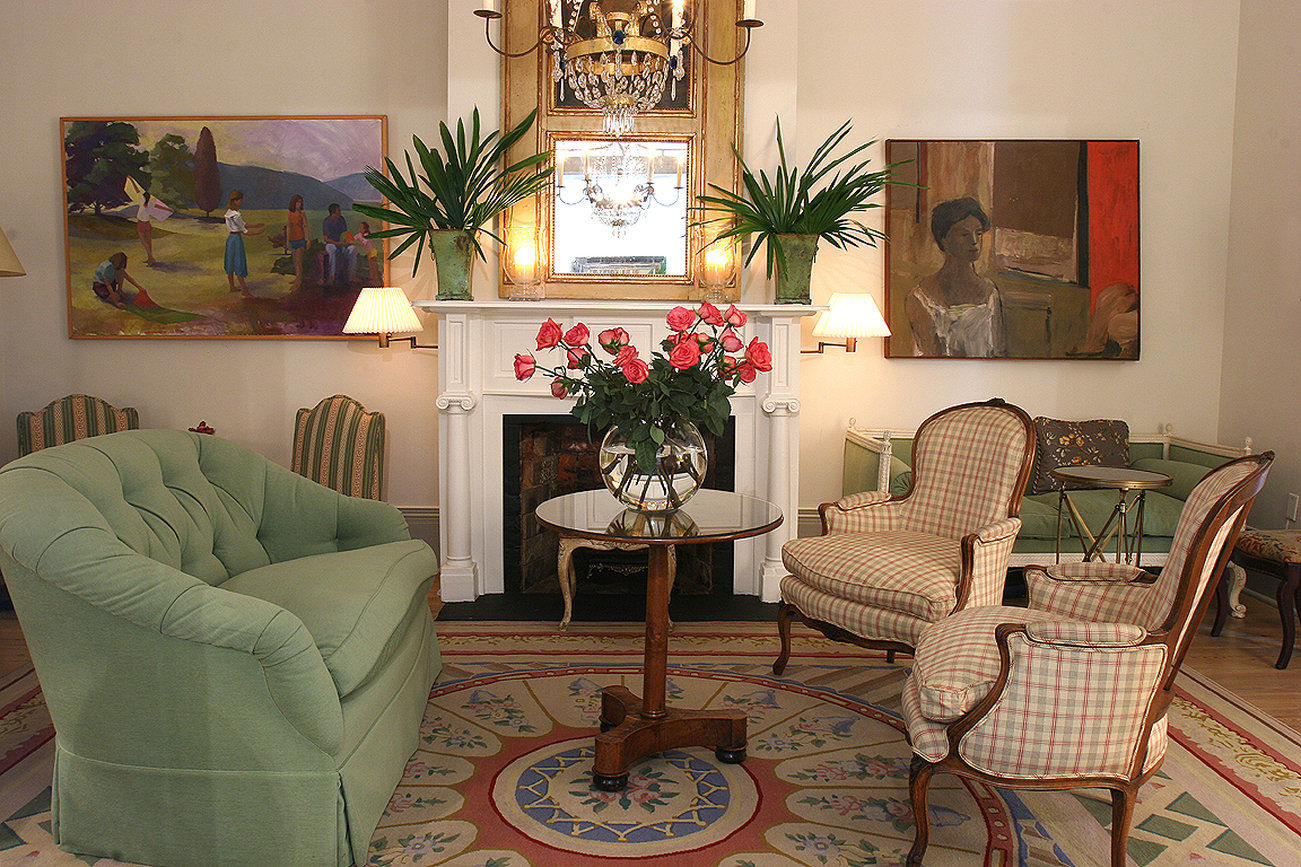 A luxurious lobby with a fireplace, comfortable seating, and decorative artwork.